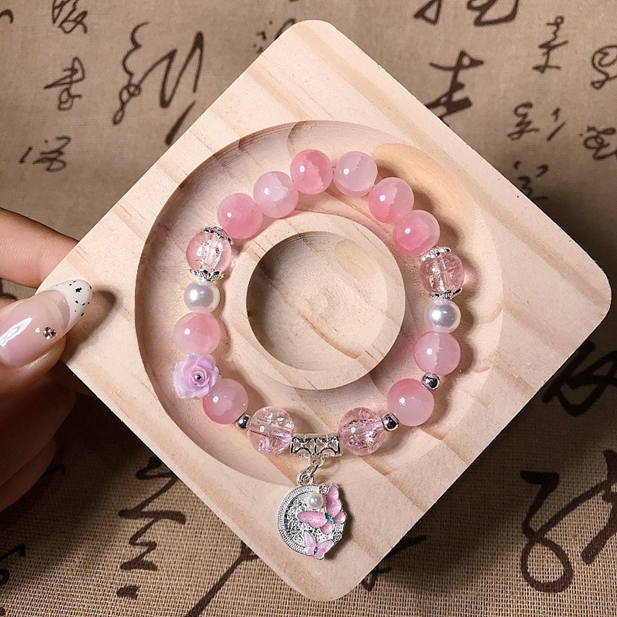 Blush Butterfly Bead Bracelet flat lay detail thumbnail